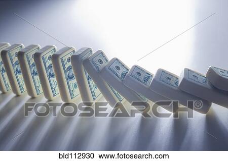 Stock Image - Close up of falling stacks of dollar bills. Fotosearch