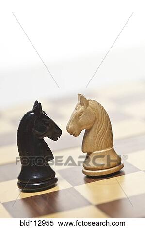 Stock Photography - Close up of knight chess pieces. Fotosearch