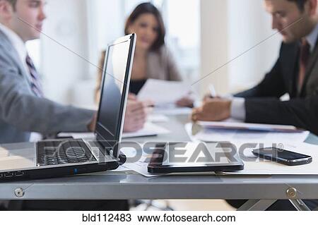 Stock Image - Close up of laptop, tablet computer and cell phone in office. Fotosearch