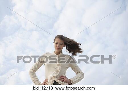 Stock Photo - Confident mixed race girl standing outdoors. Fotosearch