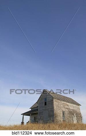 Picture - Dilapidated farmhouse under blue sky. Fotosearch
