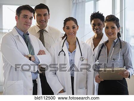Stock Image - Doctors smiling together in office. Fotosearch