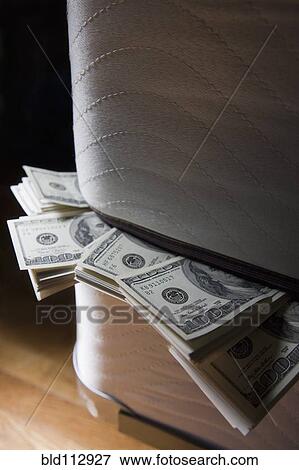 Dollar bills stuffed between mattresses View Large Photo Image Stock Photo - Dollar bills stuffed between mattresses. Fotosearch