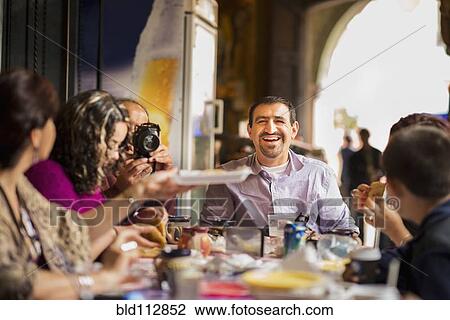 Family having dinner together at table View Large Photo Image Stock Image - Family having dinner together at table. Fotosearch