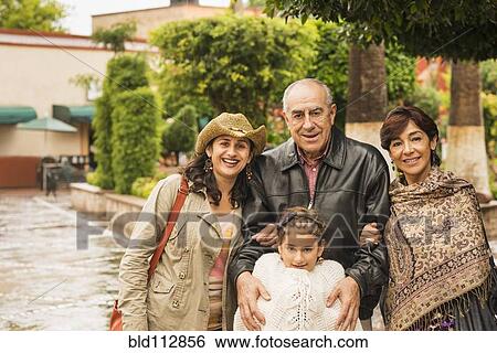 Stock Photograph - Family smiling together outdoors. Fotosearch