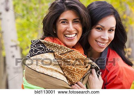 Friends hugging in forest View Large Photo Image Stock Image - Friends hugging in forest. Fotosearch