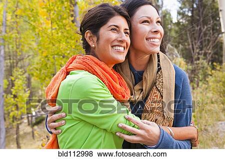 Friends hugging in forest View Large Photo Image Stock Photo - Friends hugging in forest. Fotosearch