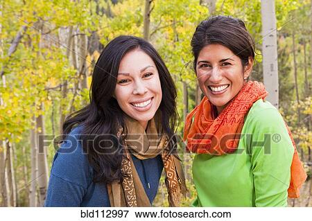 Friends standing in forest together View Large Photo Image Stock Photo - Friends standing in forest together. Fotosearch