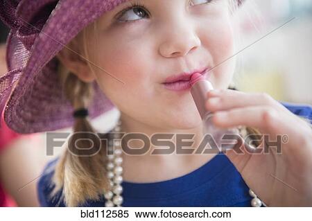 Stock Photography - Girl playing dress up with lipstick. Fotosearch