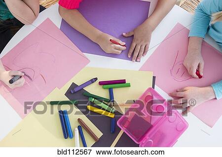 Girls coloring at desk View Large Photo Image Stock Photo - Girls coloring at desk. Fotosearch