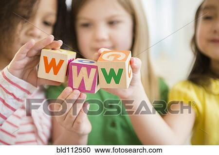 Girls holding colorful 'w' blocks View Large Photo Image Stock Image - Girls holding colorful 'w' blocks. Fotosearch