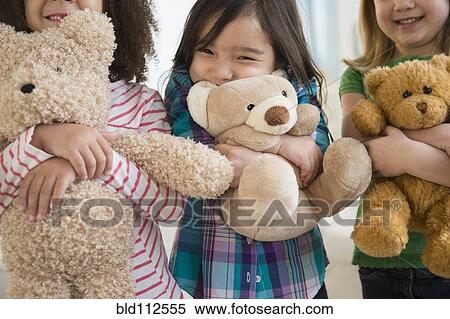 Stock Photography - Girls hugging teddy bears. Fotosearch
