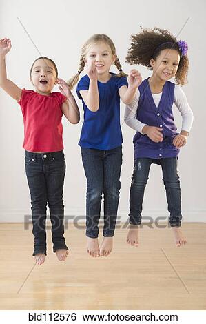 Girls jumping for joy together View Large Photo Image Stock Photograph - Girls jumping for joy together. Fotosearch