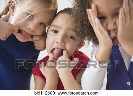 Stock Image - Girls making faces together. Fotosearch