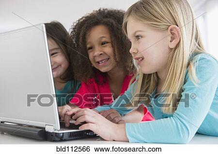Girls using laptop together View Large Photo Image Stock Photograph - Girls using laptop together. Fotosearch