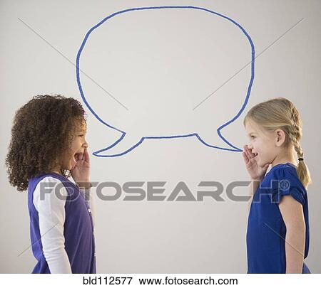 Girls whispering with empty speech bubble View Large Photo Image Stock Photo - Girls whispering with empty speech bubble. Fotosearch