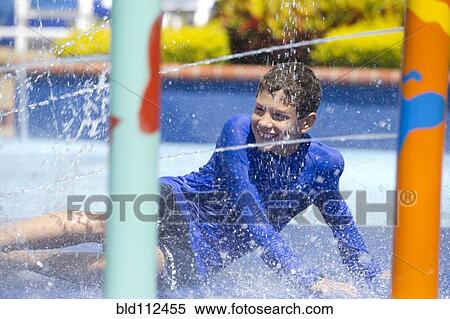 Hispanic boy playing at water park View Large Photo Image Stock Photography - Hispanic boy playing at water park. Fotosearch