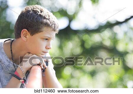 Hispanic boy sitting outdoors View Large Photo Image Stock Image - Hispanic boy sitting outdoors. Fotosearch