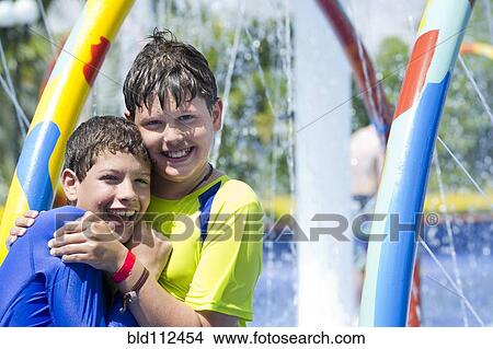 Picture - Hispanic children playing at water park. Fotosearch