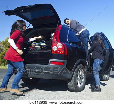 Hispanic family packing up car View Large Photo Image Stock Photography - Hispanic family packing up car. Fotosearch