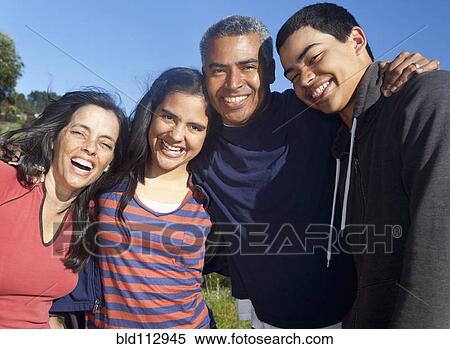 Stock Photography - Hispanic family smiling in park. Fotosearch