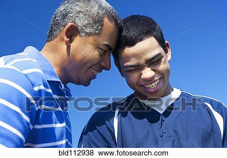 Hispanic father and son playing in park View Large Photo Image Stock Photo - Hispanic father and son playing in park. Fotosearch