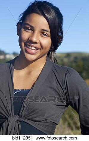 Hispanic teenage girl smiling outdoors View Large Photo Image Stock Image - Hispanic teenage girl smiling outdoors. Fotosearch