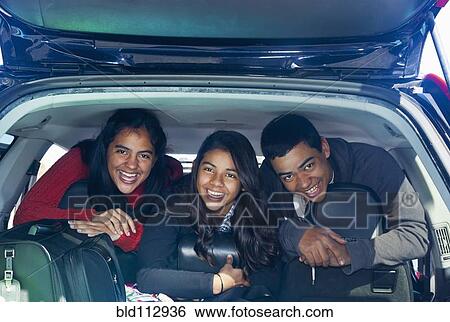Hispanic teenagers smiling in car View Large Photo Image Stock Photograph - Hispanic teenagers smiling in car. Fotosearch
