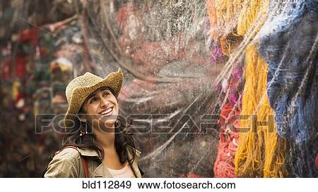 Hispanic woman admiring yarn for sale View Large Photo Image Stock Photo - Hispanic woman admiring yarn for sale. Fotosearch