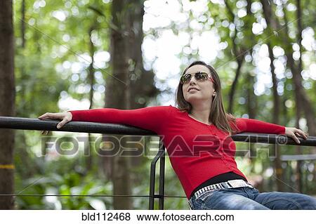 Hispanic woman relaxing outdoors View Large Photo Image Stock Photo - Hispanic woman relaxing outdoors. Fotosearch