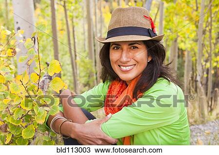 Hispanic woman sitting in forest View Large Photo Image Stock Image - Hispanic woman sitting in forest. Fotosearch