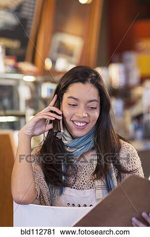 Mixed race woman working in coffee shop View Large Photo Image Stock Image - Mixed race woman working in coffee shop. Fotosearch