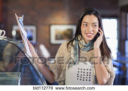 Mixed race woman working in coffee shop View Large Photo Image Stock Photo - Mixed race woman working in coffee shop. Fotosearch