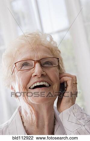 Older Hispanic woman talking on cell phone View Large Photo Image Stock Image - Older Hispanic woman talking on cell phone. Fotosearch