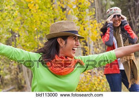 Playful friends enjoying forest View Large Photo Image Stock Image - Playful friends enjoying forest. Fotosearch