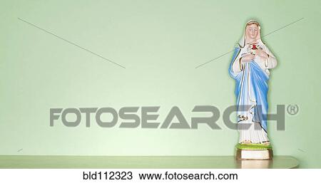 Stock Image - Religious figurine on counter top. Fotosearch