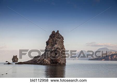 Stock Photo - Rock formations in ocean, Isle Vulcano, Sicily, Italy. Fotosearch