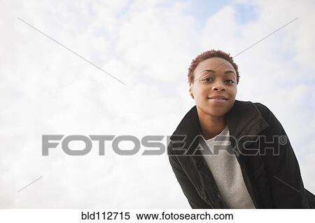 Smiling African American woman standing outdoors View Large Photo Image Stock Photography - Smiling African American woman standing outdoors. Fotosearch