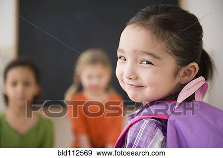 Stock Photo - Smiling girl looking over her shoulder. Fotosearch