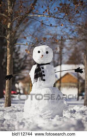 Snowman wearing scarf outdoors View Large Photo Image Picture - Snowman wearing scarf outdoors. Fotosearch