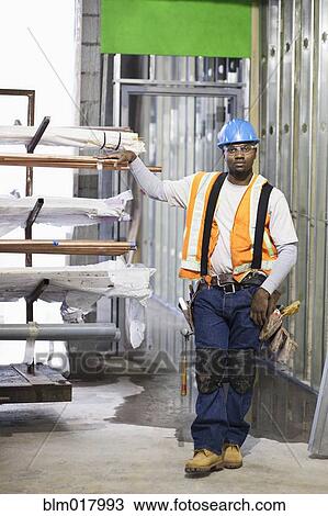 African American worker organizing metal on site View Large Photo Image Stock Image - African American worker organizing metal on site. Fotosearch
