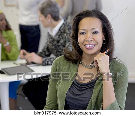 Stock Photography - Black businesswoman smiling in office. Fotosearch