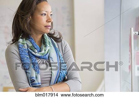 Picture - Black businesswoman standing in office. Fotosearch