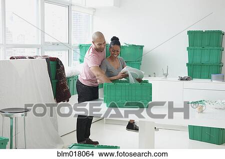 Picture - Black couple moving into new house. Fotosearch