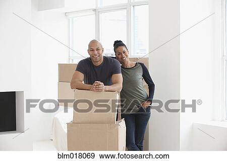 Black couple smiling in new house View Large Photo Image Stock Photo - Black couple smiling in new house. Fotosearch