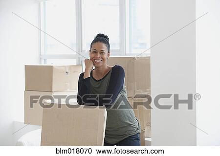 Black woman smiling in new house View Large Photo Image Stock Image - Black woman smiling in new house. Fotosearch