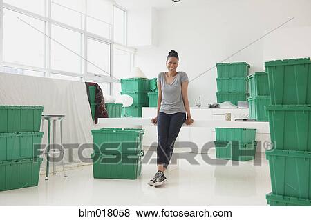 Stock Photo - Black woman smiling in new house. Fotosearch