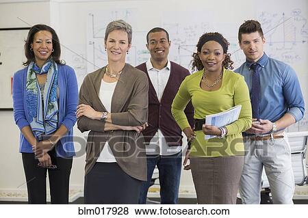 Business people smiling in office View Large Photo Image Stock Photo - Business people smiling in office. Fotosearch