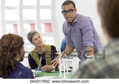 Stock Image - Business people talking in meeting. Fotosearch