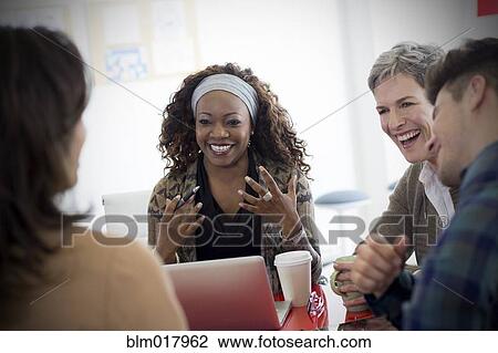 Stock Image - Business people talking in meeting. Fotosearch